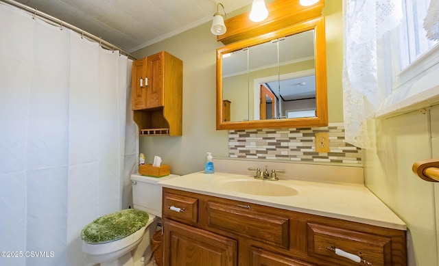 bathroom with ornamental molding, toilet, vanity, and backsplash