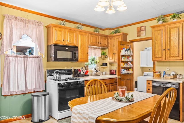 kitchen featuring sink, ornamental molding, black appliances, washer / clothes dryer, and a chandelier