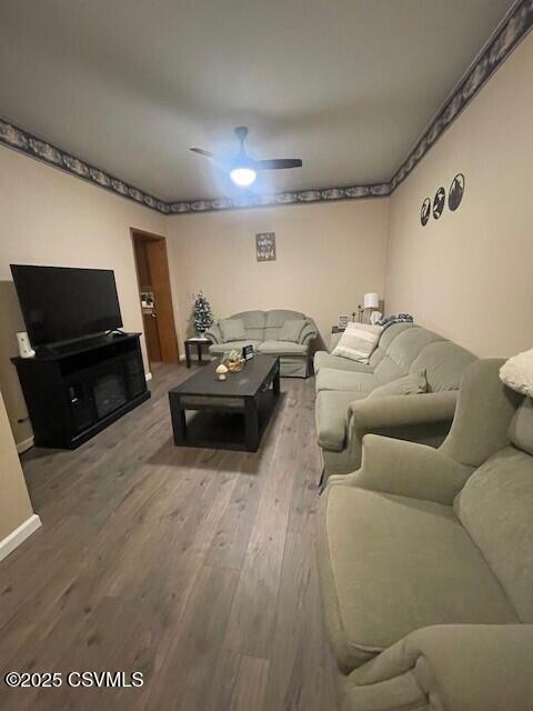 living room with hardwood / wood-style flooring and ceiling fan