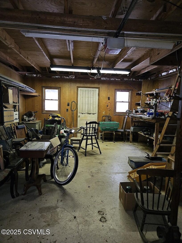 garage with a garage door opener and a workshop area