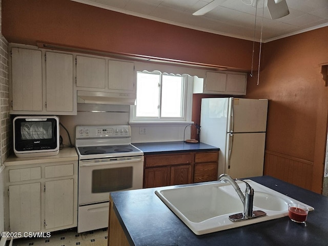 kitchen featuring crown molding, sink, and white appliances