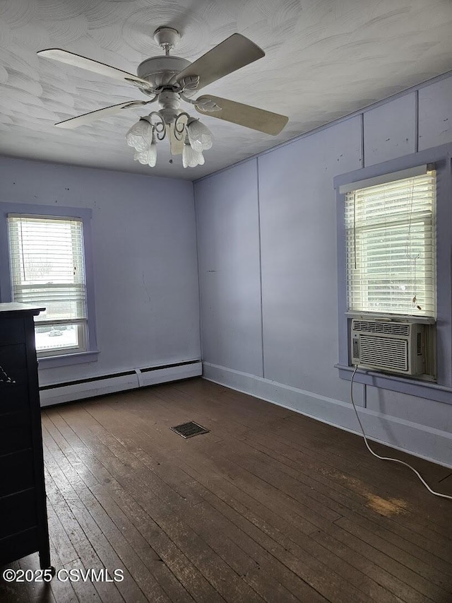 unfurnished room with dark wood-type flooring, baseboard heating, cooling unit, and ceiling fan