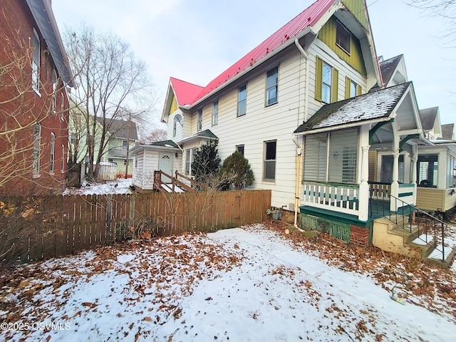 view of snowy exterior with a porch