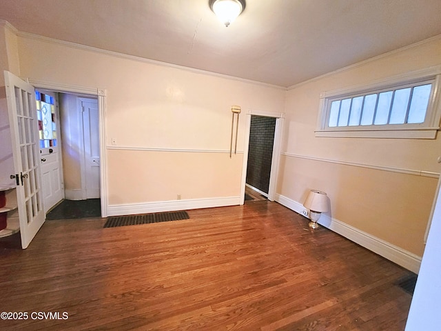 empty room with dark hardwood / wood-style floors and ornamental molding