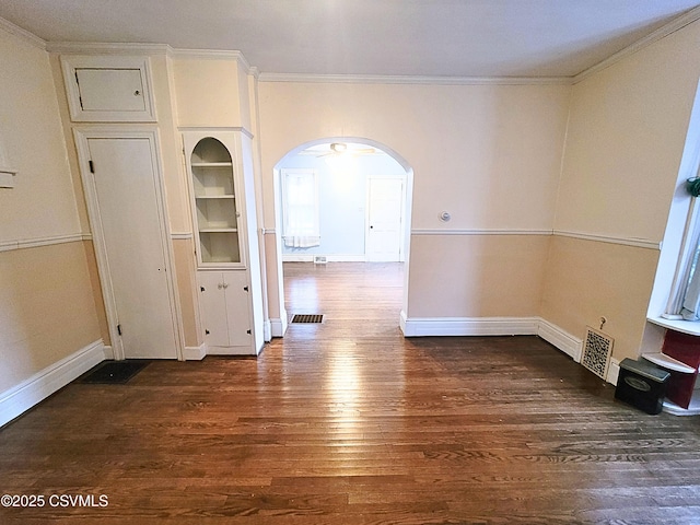 interior space with ornamental molding and dark hardwood / wood-style floors