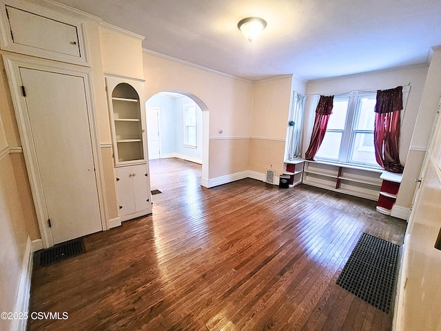 unfurnished room featuring crown molding and dark hardwood / wood-style floors