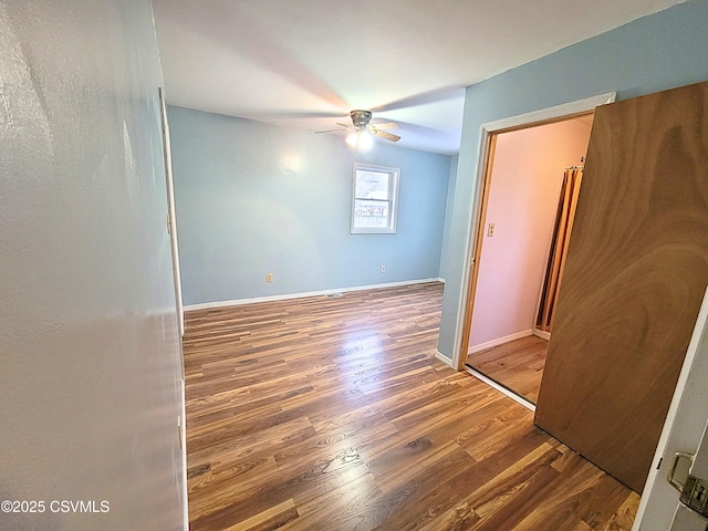 unfurnished room featuring ceiling fan and wood-type flooring