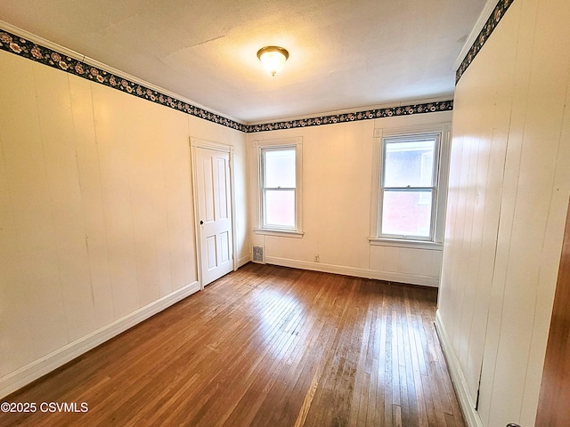 unfurnished room featuring hardwood / wood-style flooring