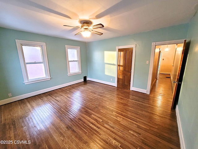 unfurnished bedroom with dark wood-type flooring and ceiling fan