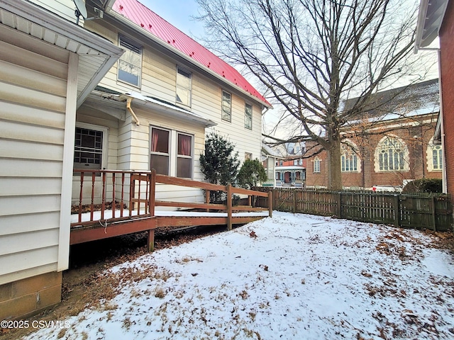 snowy yard with a deck