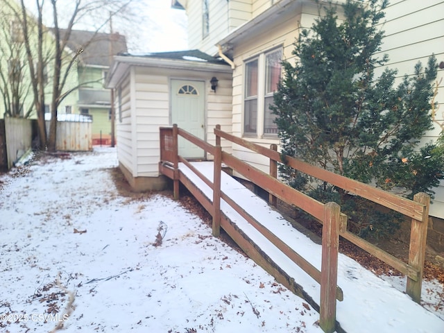 view of snow covered property entrance