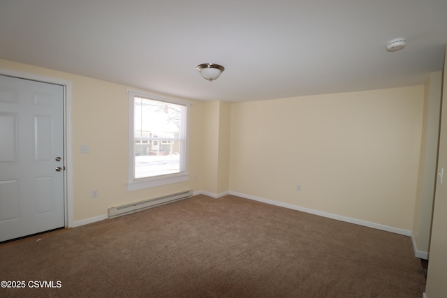 spare room with a baseboard radiator and dark colored carpet