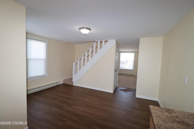 interior space with dark wood-type flooring and a baseboard radiator