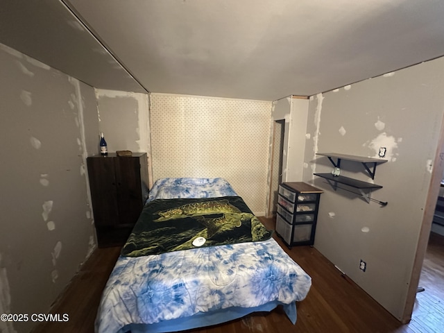 bedroom with dark hardwood / wood-style flooring