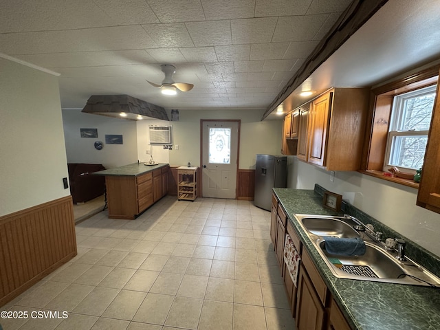 kitchen with plenty of natural light, stainless steel fridge, sink, and a wall unit AC