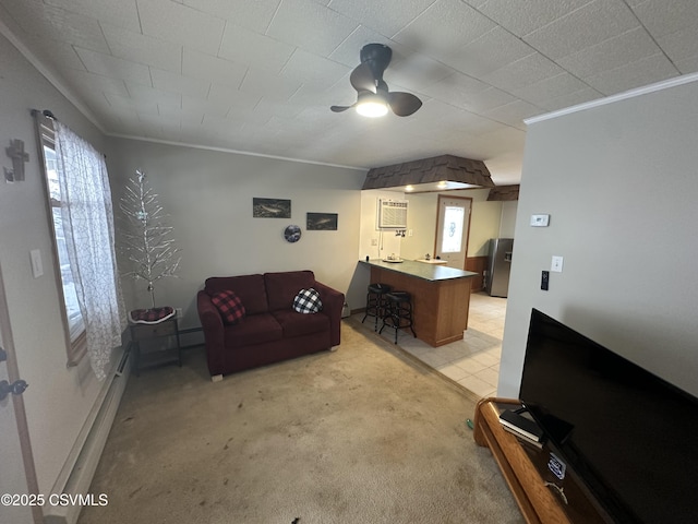 living room featuring a wall mounted AC, light carpet, baseboard heating, ornamental molding, and ceiling fan