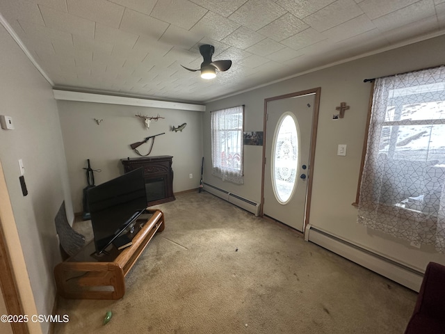 entrance foyer with ornamental molding, carpet, ceiling fan, and baseboard heating