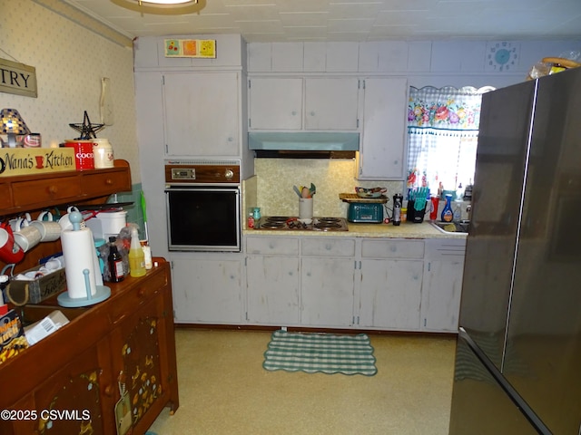 kitchen with white cabinets and appliances with stainless steel finishes