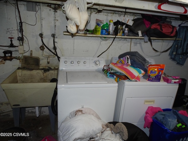 clothes washing area featuring sink and washing machine and clothes dryer