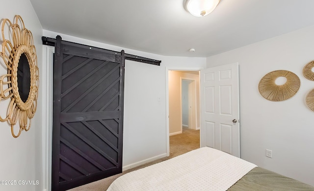 carpeted bedroom with a barn door