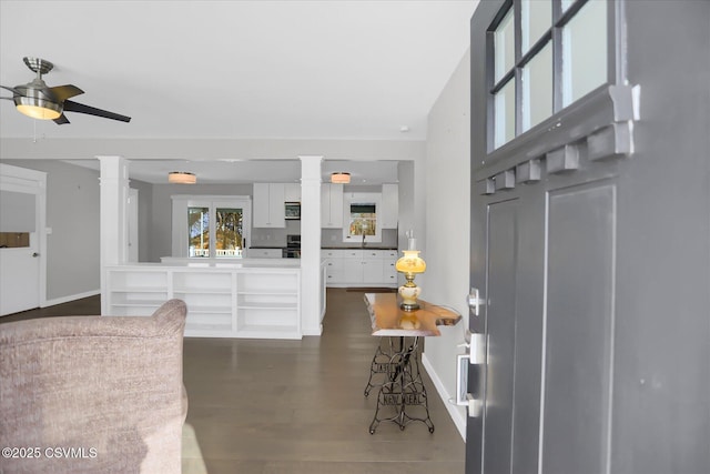 entryway with ceiling fan and ornate columns