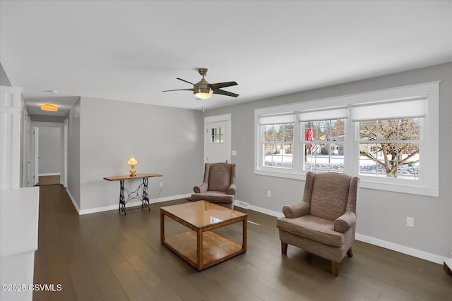 sitting room featuring dark wood-type flooring and ceiling fan