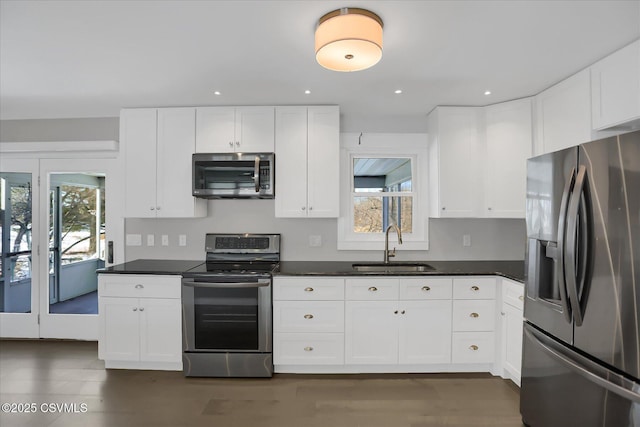 kitchen featuring sink, plenty of natural light, white cabinets, and appliances with stainless steel finishes