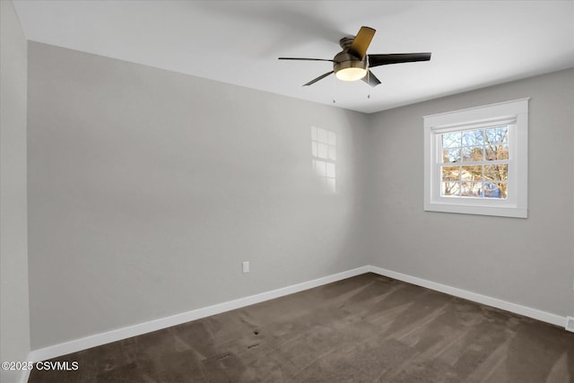 carpeted spare room with ceiling fan