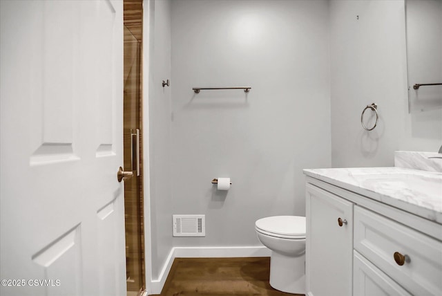 bathroom with vanity, hardwood / wood-style floors, and toilet