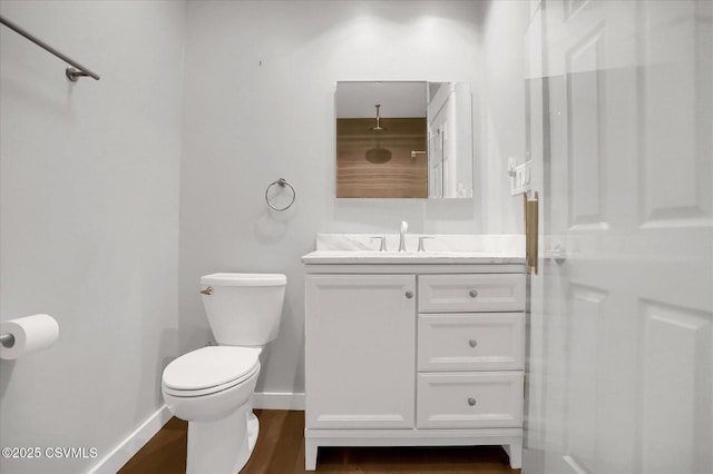 bathroom featuring vanity, wood-type flooring, and toilet