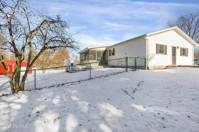 view of snow covered rear of property