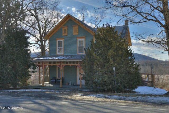 view of front of home featuring a mountain view and covered porch