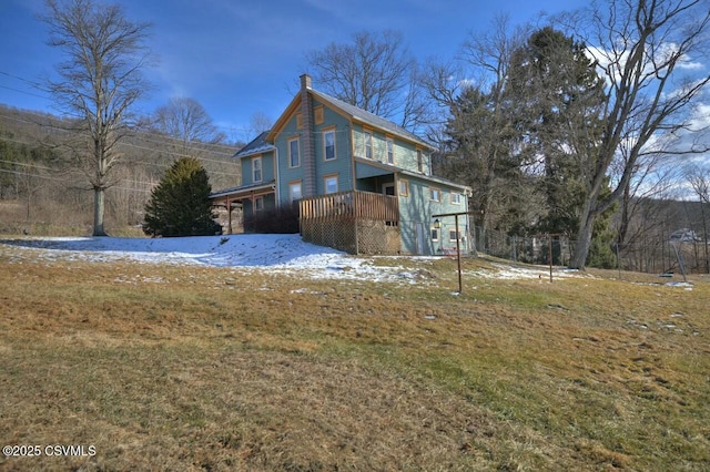 view of snow covered exterior featuring a yard