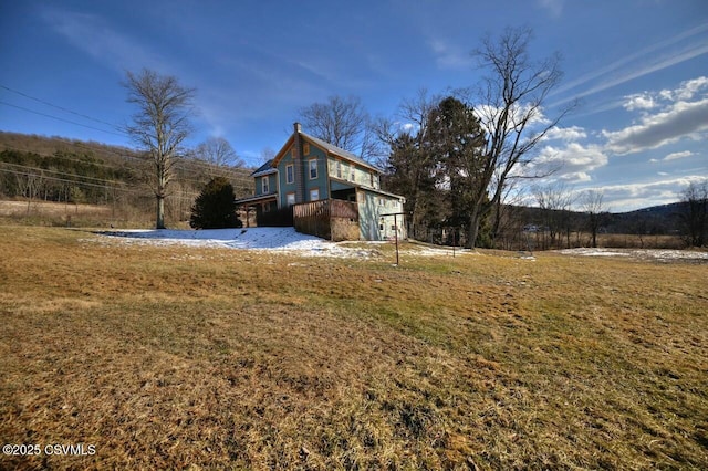 view of side of home featuring a yard