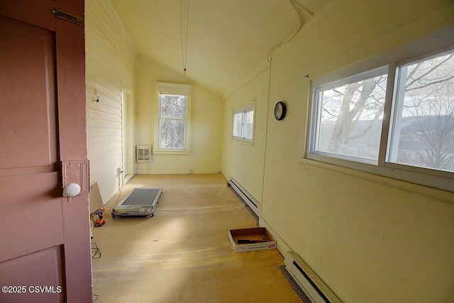 interior space with lofted ceiling, a baseboard heating unit, and a wall mounted AC