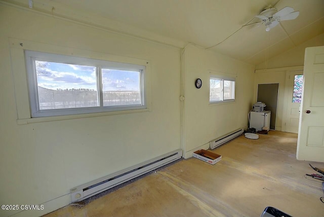 spare room featuring a baseboard radiator, a healthy amount of sunlight, and vaulted ceiling