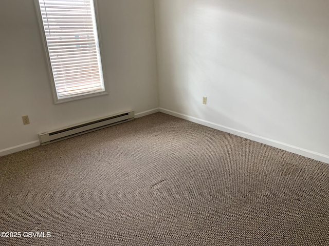 carpeted spare room featuring baseboard heating