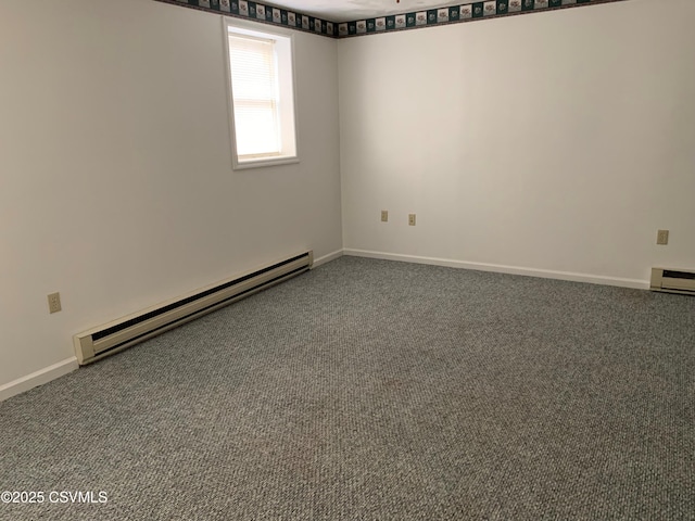 carpeted spare room with a baseboard radiator