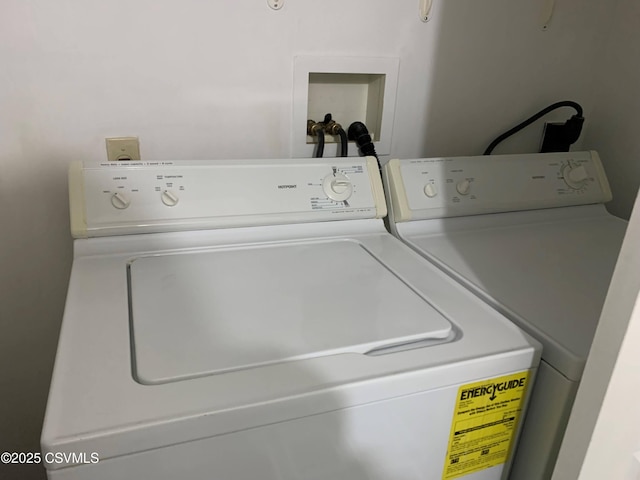 clothes washing area with separate washer and dryer