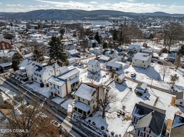 snowy aerial view featuring a mountain view