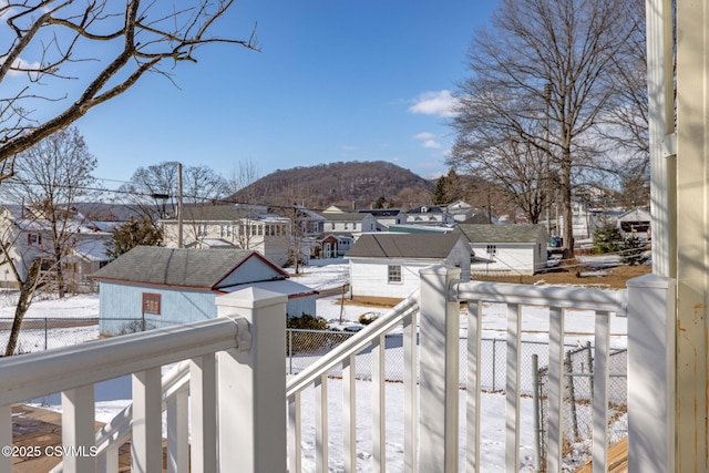 snow covered deck with a mountain view