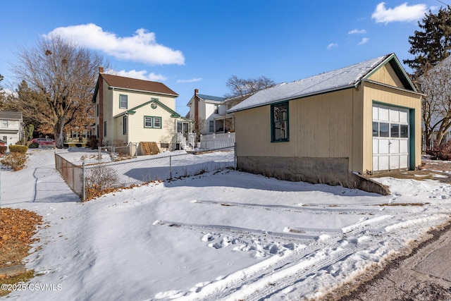 view of snowy exterior featuring a garage