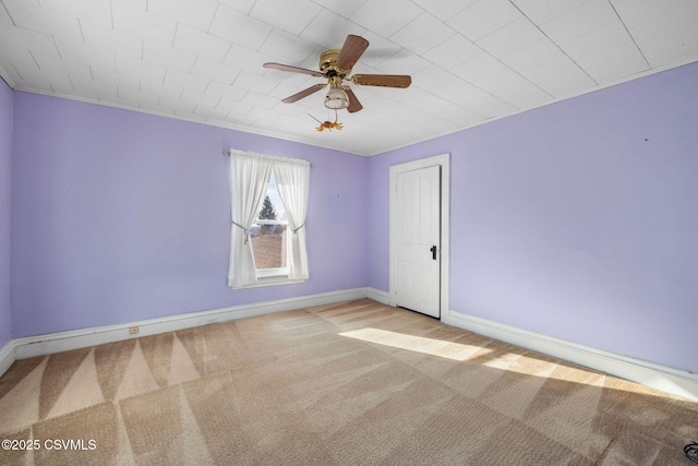 spare room with light colored carpet and ceiling fan