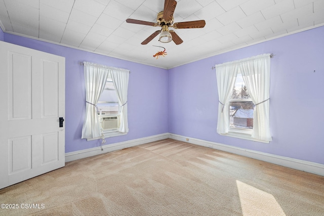 carpeted spare room featuring cooling unit, a wealth of natural light, and ceiling fan