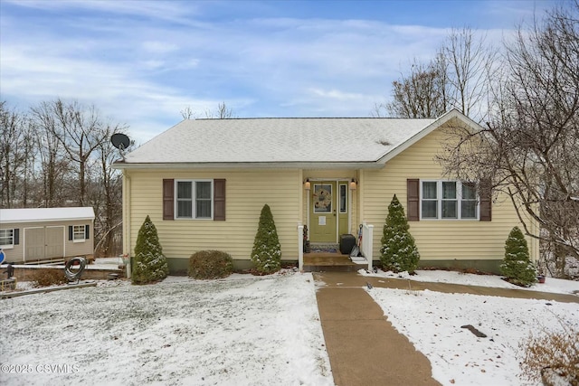 view of front of house with a storage shed