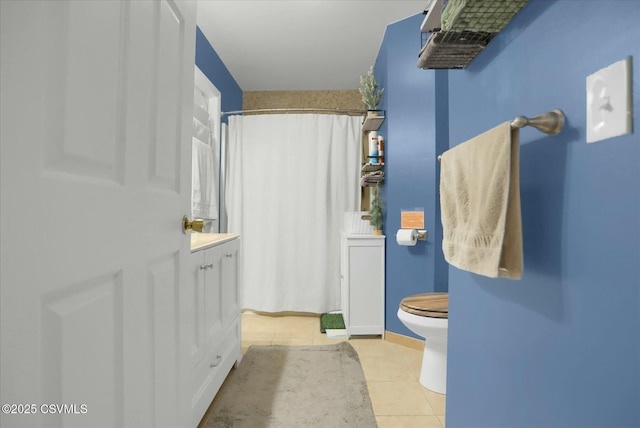 bathroom with vanity, curtained shower, tile patterned floors, and toilet