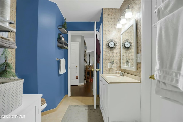 bathroom with vanity, toilet, tile patterned flooring, and decorative backsplash