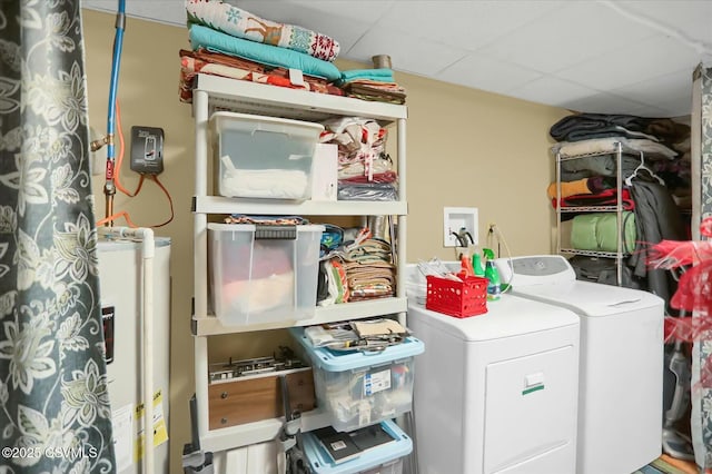 laundry area featuring water heater and washer and dryer