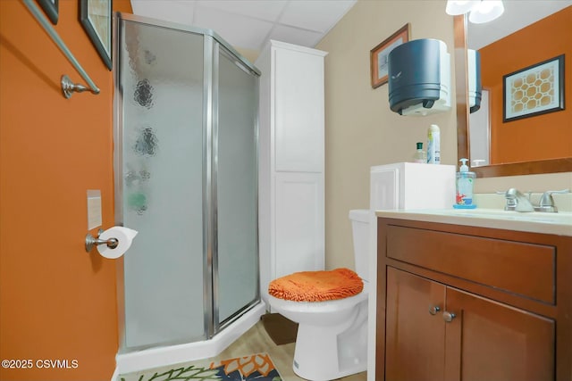 bathroom featuring vanity, a shower with door, and toilet