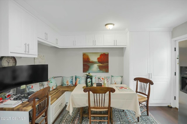 dining space with dark hardwood / wood-style flooring